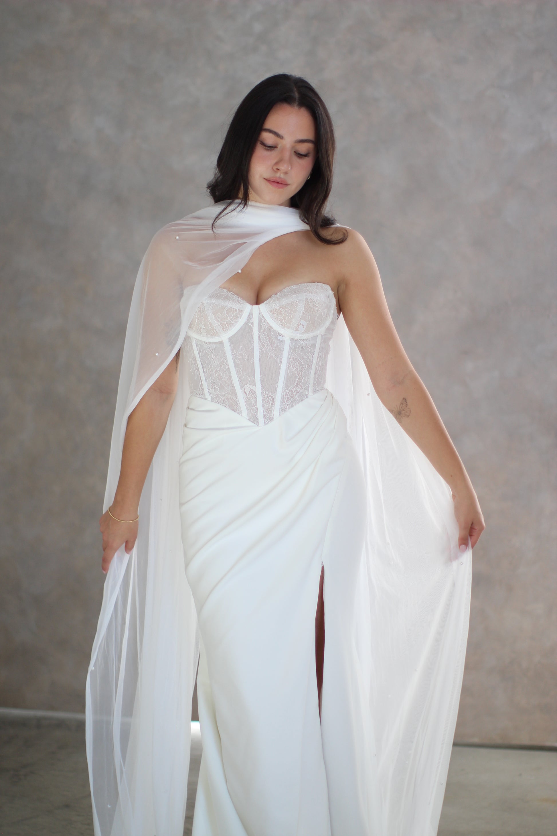 Pearl bridal neck scarf being worn over bodice of a wedding dress