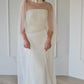 Bride wearing sheer wedding shawl over modern wedding dress